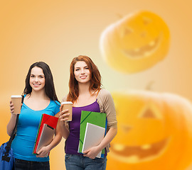 Image showing smiling student girls with books and paper cups