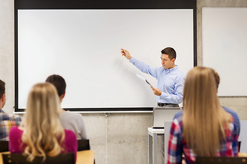 Image showing group of students and teacher with notepad