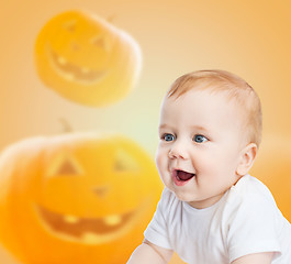 Image showing smiling baby over pumpkins background