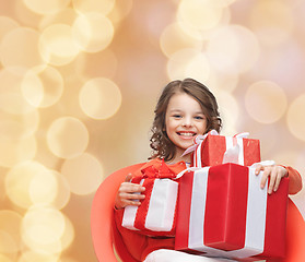Image showing smiling little girl with gift boxes