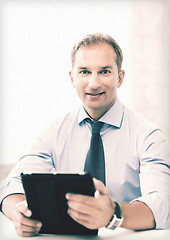 Image showing businessman with tablet pc in office