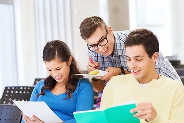 Image showing group of smiling students with notebooks