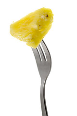 Image showing Pineapple held by a fork

