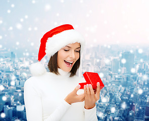 Image showing smiling woman in santa helper hat with gift box