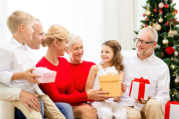 Image showing smiling family with gifts at home