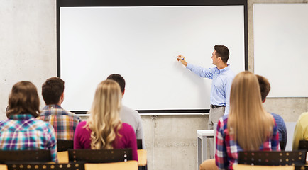 Image showing group of students and smiling teacher in classroom