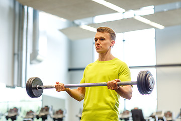 Image showing man doing exercise with barbell in gym