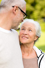 Image showing senior couple hugging in city park