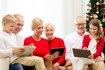 Image showing smiling family with tablet pc computers at home