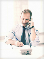 Image showing handsome businessman talking on the phone