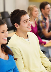 Image showing group of smiling students in lecture hall