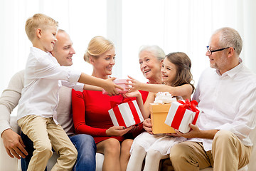 Image showing smiling family with gifts at home