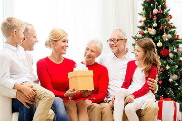 Image showing smiling family with gifts at home