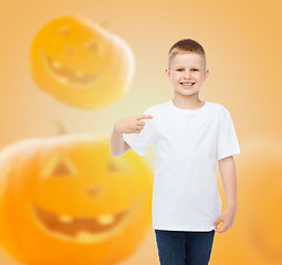 Image showing smiling boy over pumpkins background