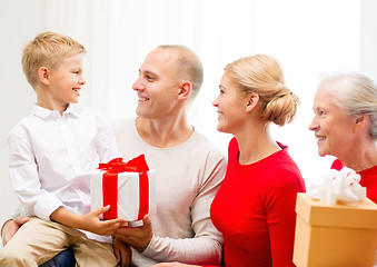 Image showing smiling family with gifts at home