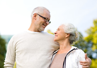 Image showing senior couple hugging in city park