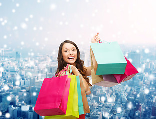 Image showing smiling woman with colorful shopping bags