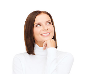 Image showing thinking and smiling woman in white sweater