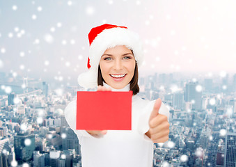 Image showing woman in santa helper hat with blank red card