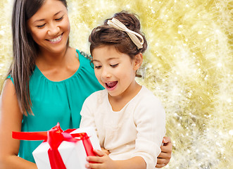 Image showing happy mother and little girl with gift box