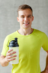 Image showing smiling man with protein shake bottle