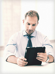 Image showing businessman with tablet pc in office