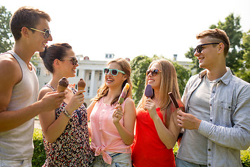 Image showing group of smiling friends with ice cream outdoors