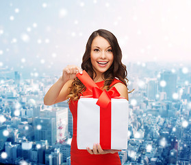 Image showing smiling woman in red dress with gift boxes