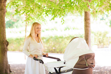 Image showing happy mother with stroller in park