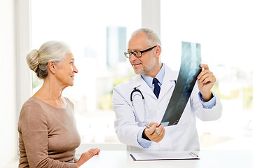 Image showing smiling senior woman and doctor meeting