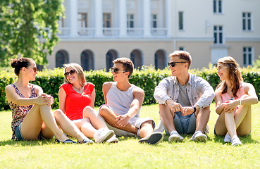 Image showing group of smiling friends outdoors sitting on grass