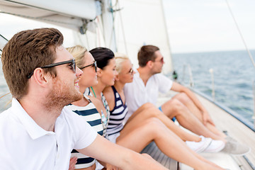 Image showing smiling friends sitting on yacht deck