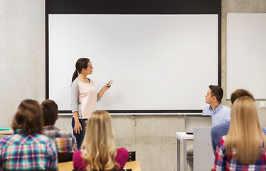 Image showing group of students and smiling teacher in classroom