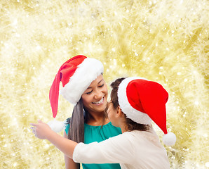 Image showing happy mother and girl in santa hats