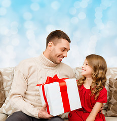 Image showing smiling father and daughter with gift box