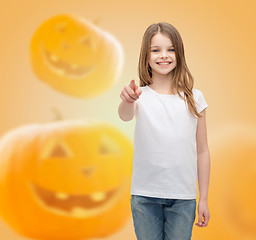 Image showing smiling girl over pumpkins background