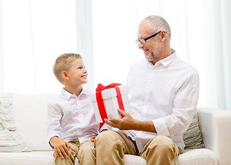 Image showing smiling grandfather and grandson at home