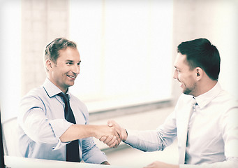 Image showing businessmen shaking hands in office