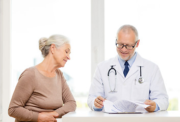 Image showing smiling senior woman and doctor meeting