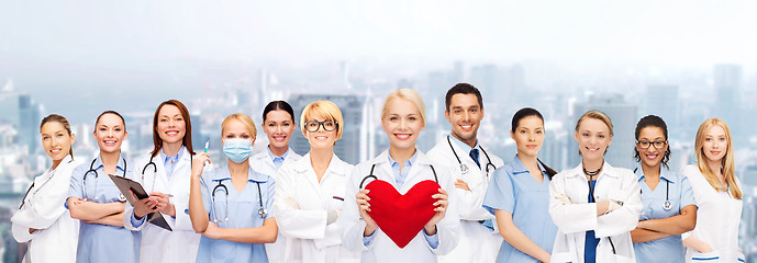 Image showing smiling doctors and nurses with red heart