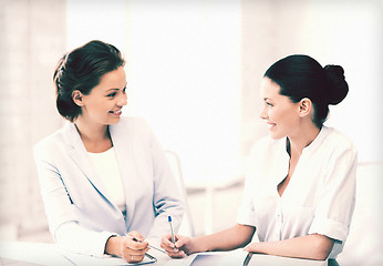 Image showing two businesswomen having discussion in office