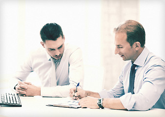 Image showing businessmen with notebook on meeting
