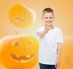 Image showing smiling boy over pumpkins background
