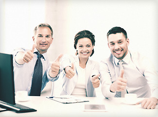 Image showing business team showing thumbs up in office