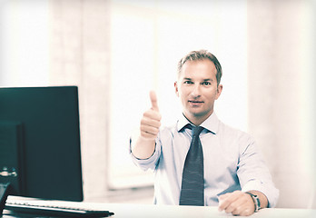 Image showing smiling businessman showing thumbs up