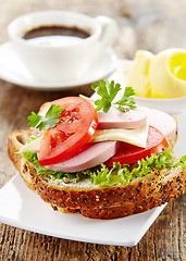 Image showing breakfast sandwich with sliced sausage and tomato