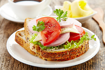 Image showing breakfast sandwich with sliced sausage and tomato