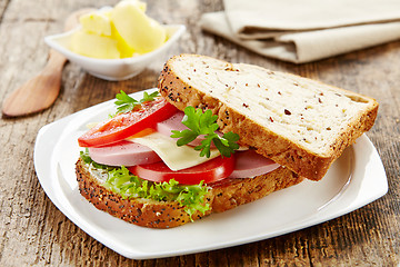 Image showing breakfast sandwich with sliced sausage and tomato