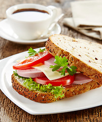 Image showing breakfast sandwich with sliced sausage and tomato