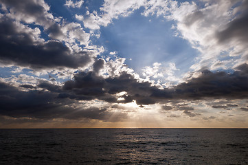 Image showing sun shining through clouds